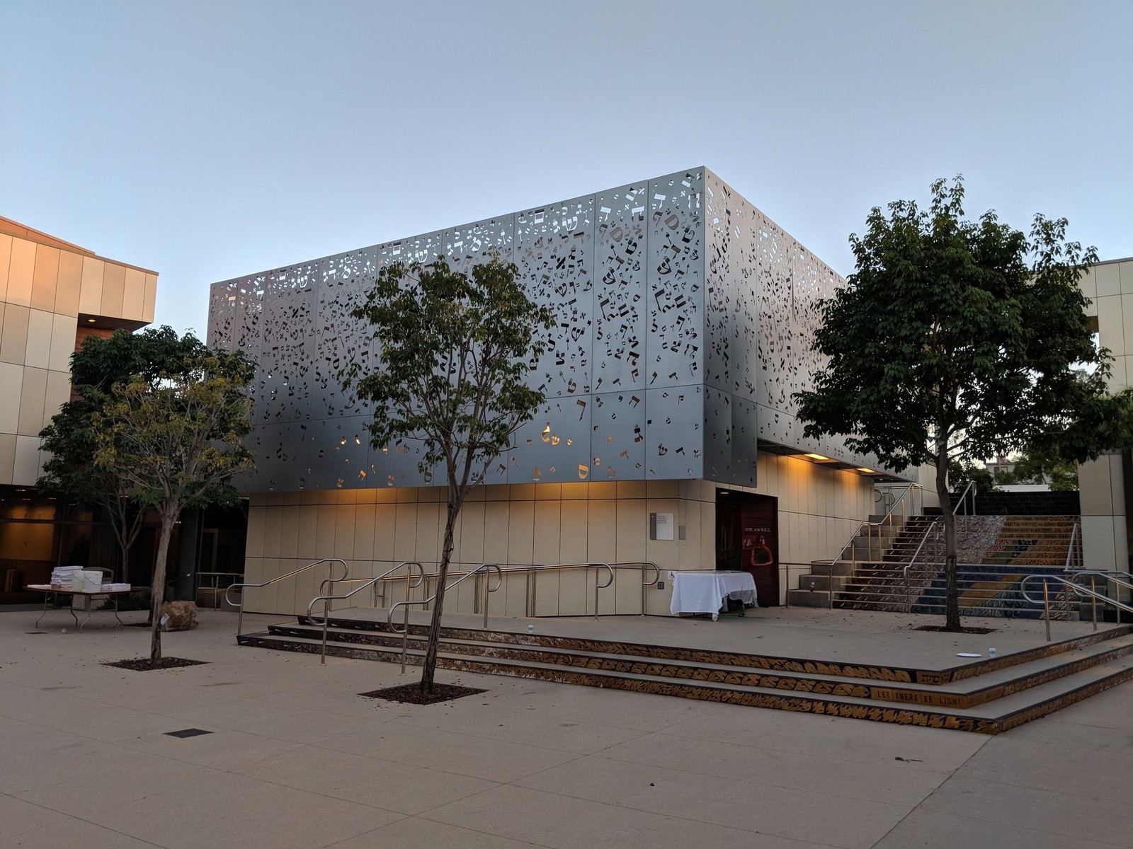A synagogue exterior with a perforated metal facade